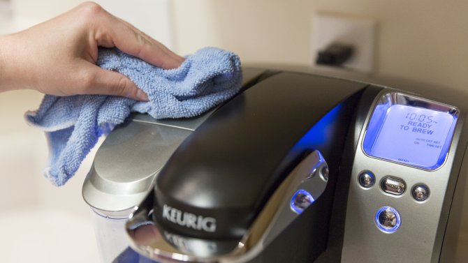 Wiping down a Keurig with a cloth